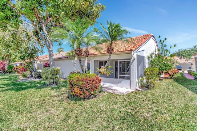 15443 Floral Club Rd, Delray Beach, FL 33484 - exterior space featuring stucco siding, a tile roof, and a lawn