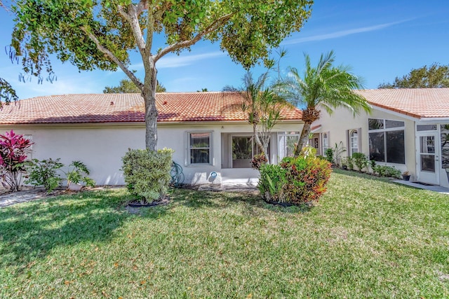 15443 Floral Club Rd, Delray Beach, FL 33484 - back of house with a tile roof, a lawn, and stucco siding