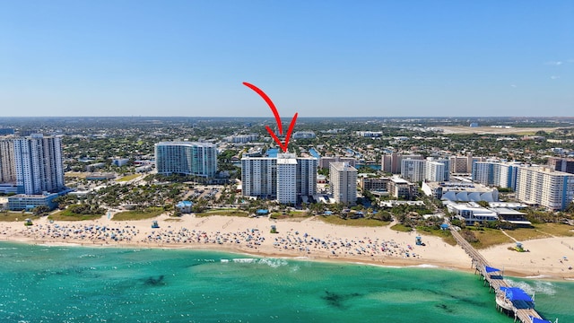 drone / aerial view with a water view, a view of city, and a view of the beach