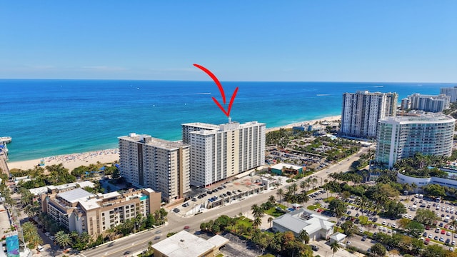 birds eye view of property with a water view and a view of city