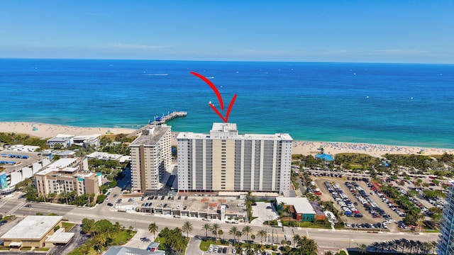 bird's eye view with a city view, a beach view, and a water view