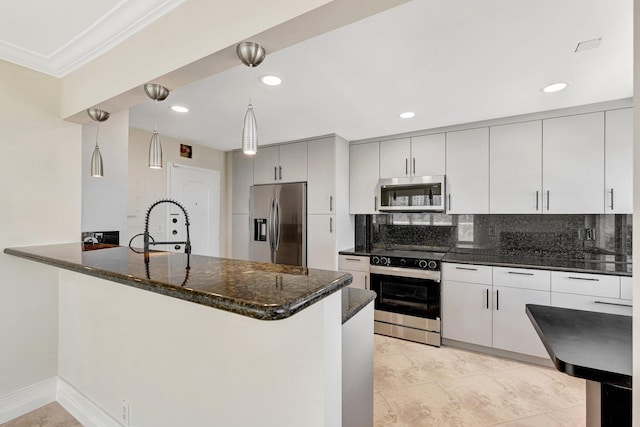 kitchen featuring dark stone countertops, backsplash, appliances with stainless steel finishes, and a peninsula