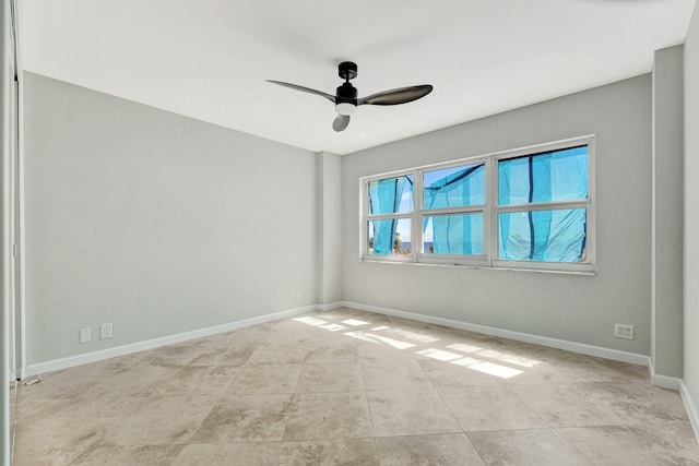 empty room with tile patterned floors, baseboards, and ceiling fan