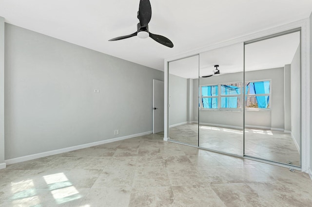 unfurnished bedroom featuring a closet, ceiling fan, and baseboards