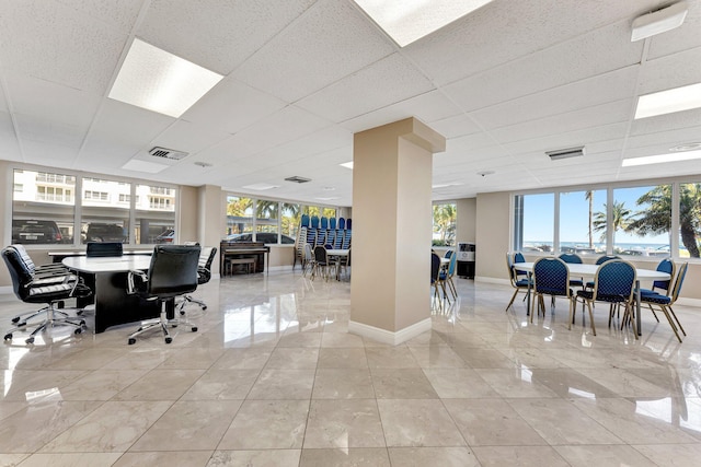 office with visible vents, a paneled ceiling, and baseboards