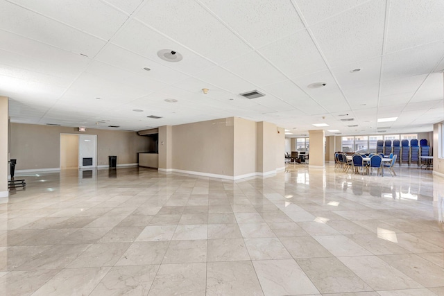 miscellaneous room featuring visible vents, a paneled ceiling, and baseboards