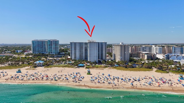 birds eye view of property with a water view, a city view, and a view of the beach