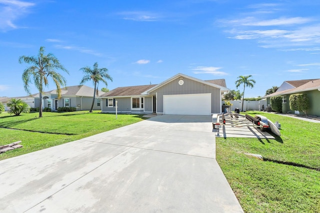 single story home with a garage, a front lawn, driveway, and fence