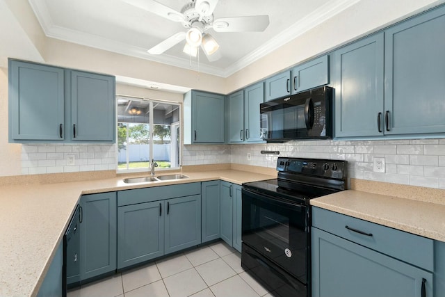 kitchen with a sink, black appliances, light countertops, crown molding, and tasteful backsplash