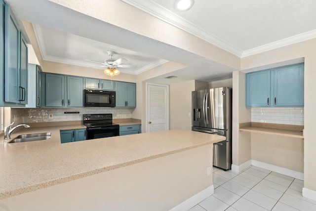 kitchen featuring a peninsula, black appliances, crown molding, and a sink