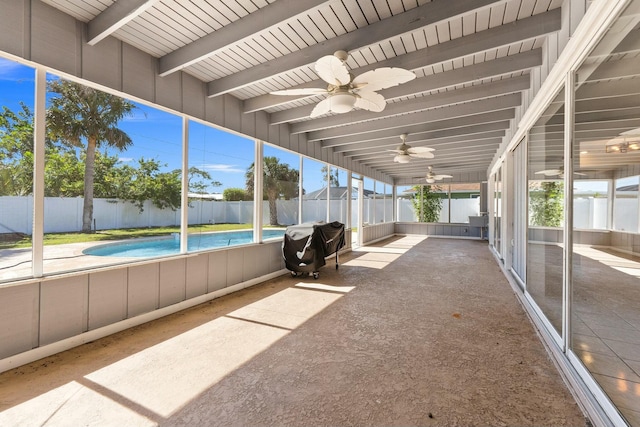 unfurnished sunroom with beamed ceiling, a healthy amount of sunlight, and ceiling fan