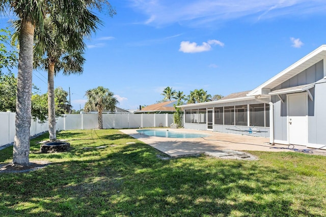 view of yard featuring a fenced in pool, a fenced backyard, and a sunroom