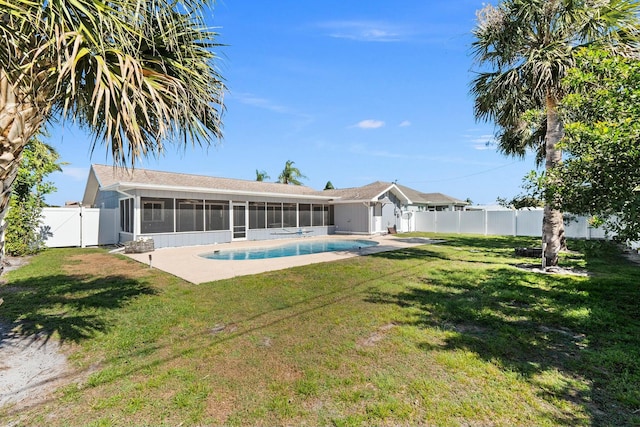 rear view of property featuring a fenced in pool, a sunroom, a yard, a fenced backyard, and a gate