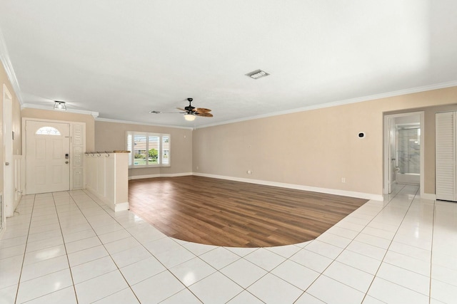 unfurnished room with ceiling fan, light tile patterned floors, visible vents, and ornamental molding