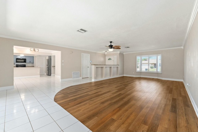 unfurnished living room with light wood finished floors, visible vents, and ornamental molding