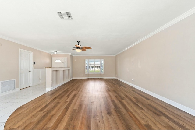 unfurnished living room featuring visible vents, crown molding, ceiling fan, and wood finished floors