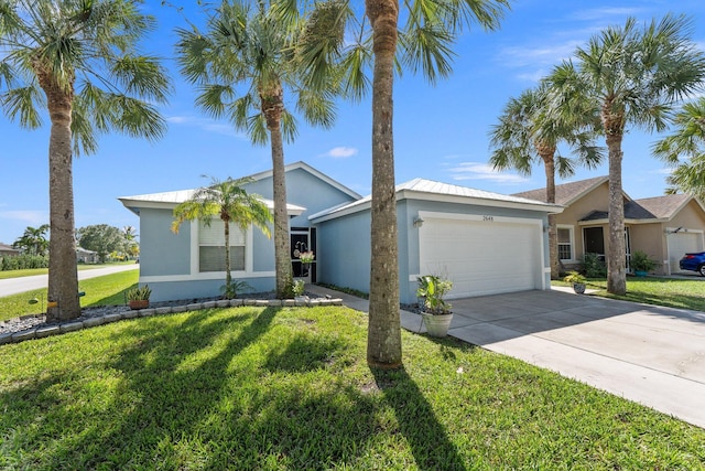 view of front facade with a garage, concrete driveway, a front lawn, and stucco siding