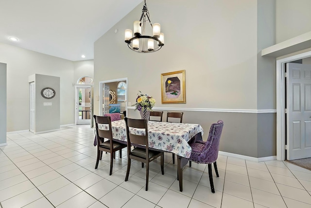 dining area featuring baseboards, a chandelier, light tile patterned floors, recessed lighting, and a high ceiling