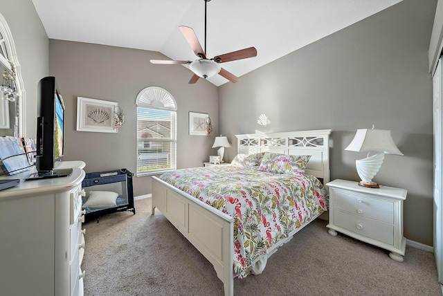 bedroom featuring lofted ceiling, light colored carpet, baseboards, and ceiling fan