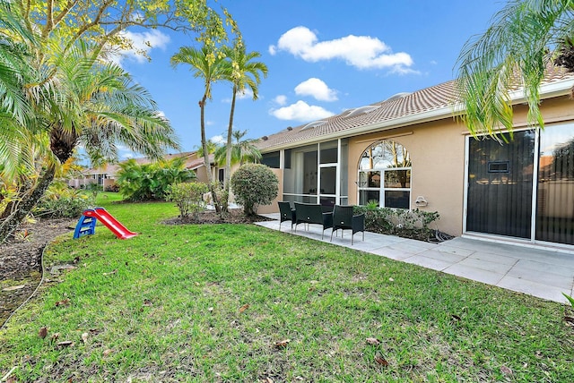 view of yard featuring a patio area and a sunroom