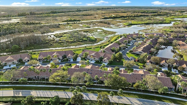 drone / aerial view featuring a residential view and a water view