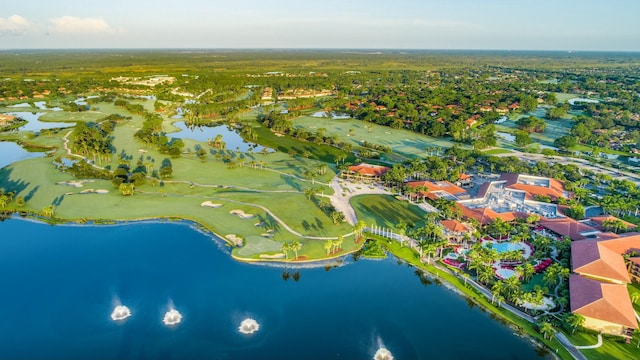 birds eye view of property with golf course view and a water view