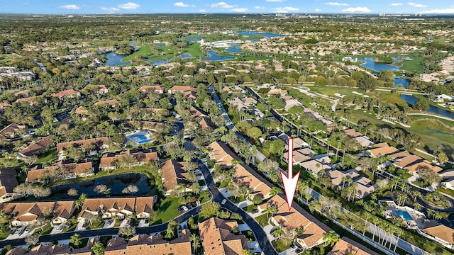 aerial view featuring golf course view, a residential view, and a water view