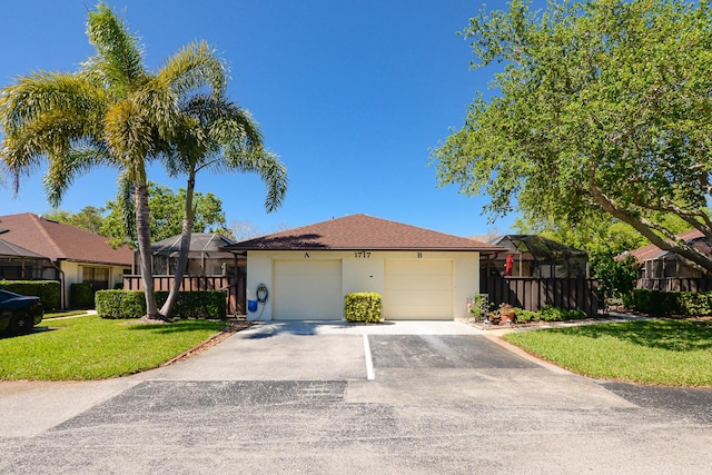 view of front facade with stucco siding, driveway, a front lawn, an attached garage, and a lanai