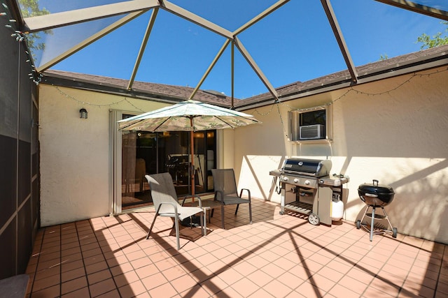 view of patio with glass enclosure, area for grilling, and cooling unit