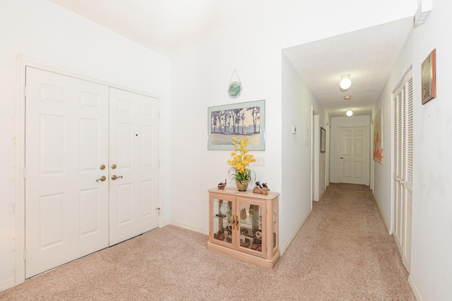 foyer featuring light carpet