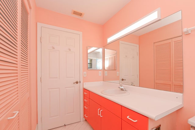 bathroom with a closet, visible vents, and vanity