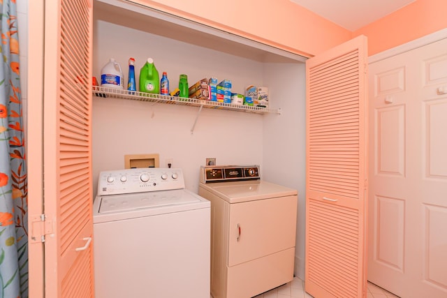 laundry area with laundry area, light tile patterned floors, and independent washer and dryer