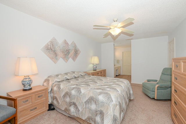 bedroom with light carpet, a textured ceiling, and ceiling fan