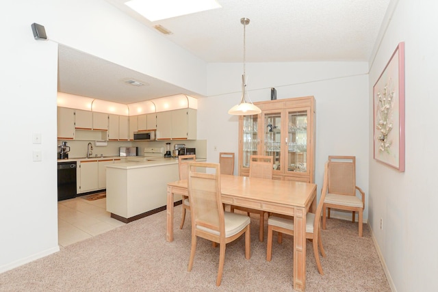 dining area with visible vents, baseboards, lofted ceiling, light carpet, and light tile patterned floors