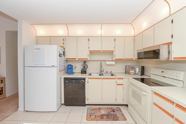 kitchen featuring light countertops, light tile patterned flooring, white appliances, a textured ceiling, and a sink