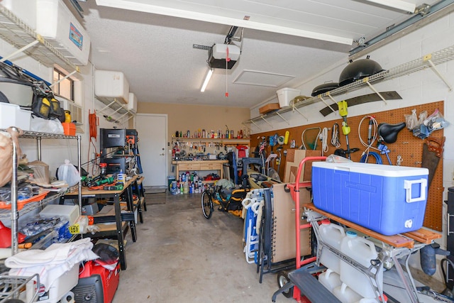 garage with a workshop area and a garage door opener