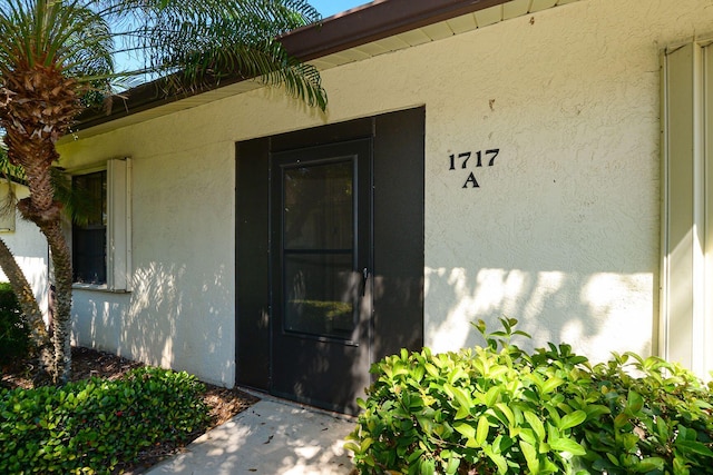 property entrance with stucco siding