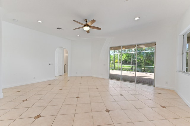 spare room with baseboards, recessed lighting, arched walkways, and ceiling fan