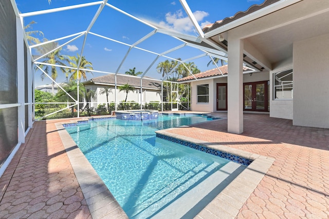 view of pool with french doors, a patio, glass enclosure, and a pool with connected hot tub