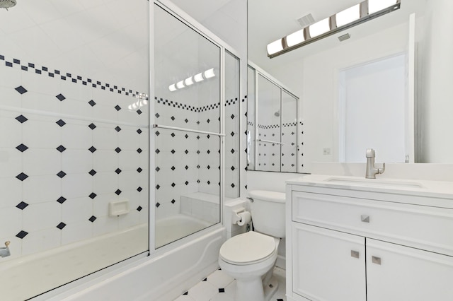 bathroom featuring vanity, toilet, visible vents, and combined bath / shower with glass door