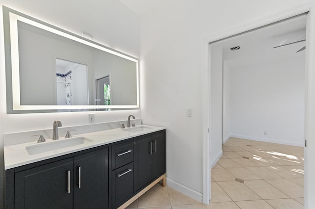 full bath featuring a sink, visible vents, double vanity, and tile patterned flooring