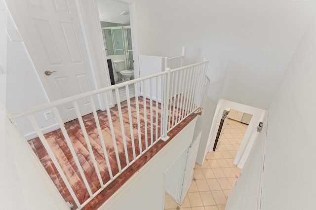 stairway with tile patterned floors