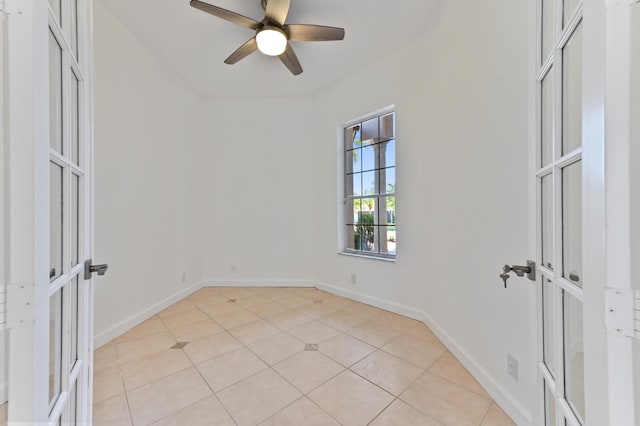 unfurnished bedroom with ceiling fan, french doors, baseboards, and light tile patterned flooring