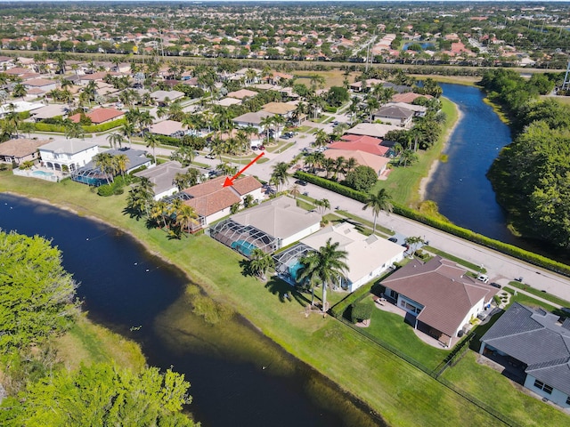 drone / aerial view with a residential view and a water view