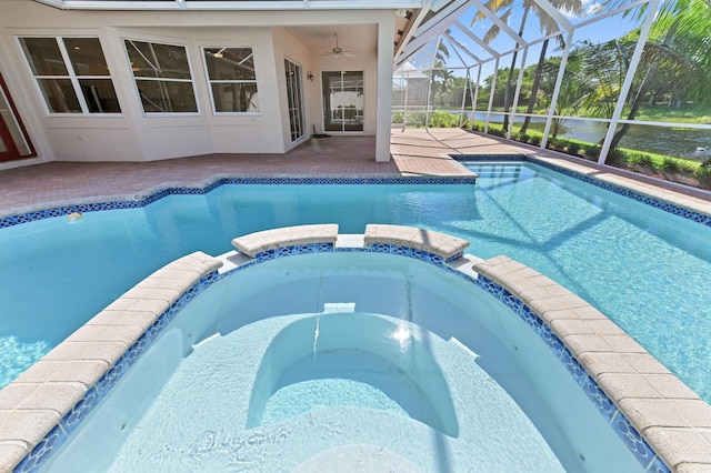 view of swimming pool featuring a patio area, a lanai, a pool with connected hot tub, and ceiling fan