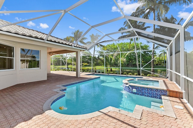 view of pool with ceiling fan, a patio, a lanai, and a pool with connected hot tub