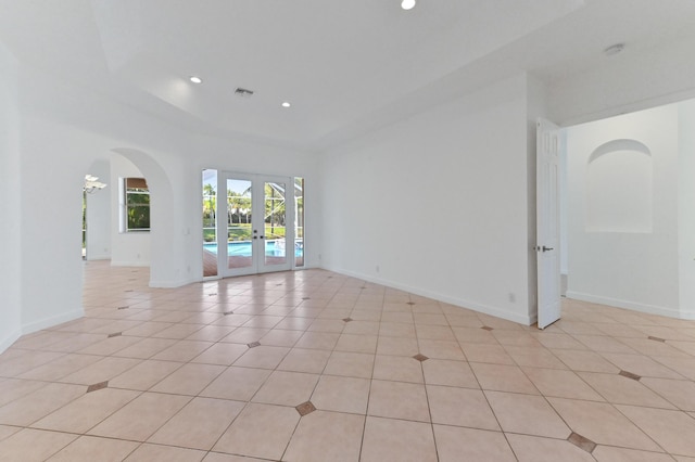 empty room featuring visible vents, baseboards, light tile patterned floors, recessed lighting, and french doors