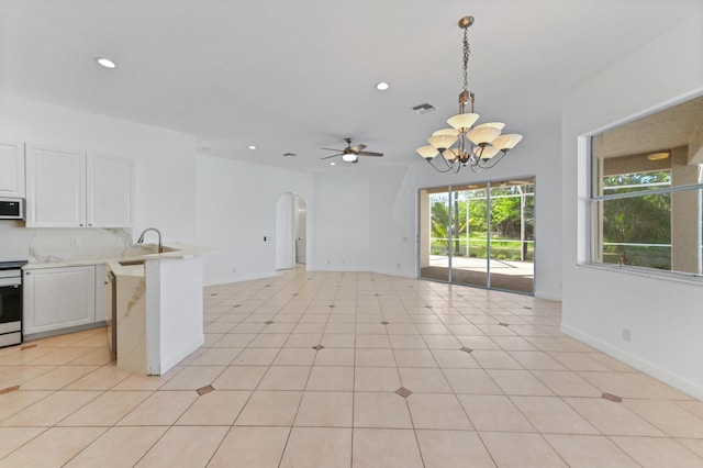 kitchen featuring white microwave, visible vents, a peninsula, light countertops, and white cabinetry