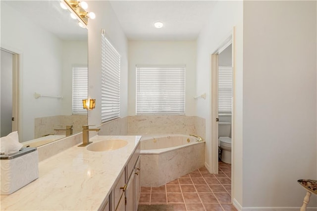 full bath featuring tile patterned flooring, a garden tub, toilet, and vanity