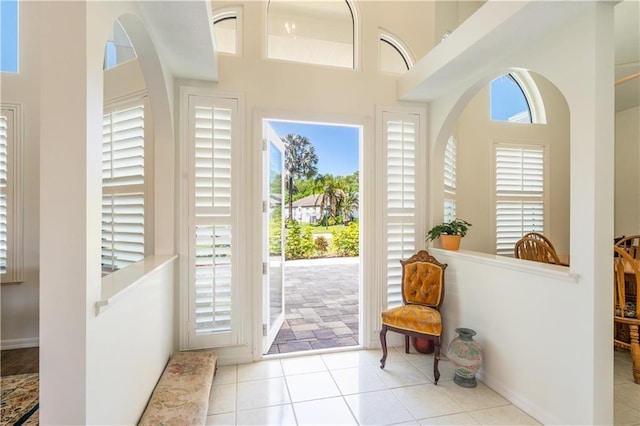 foyer entrance featuring tile patterned flooring and baseboards